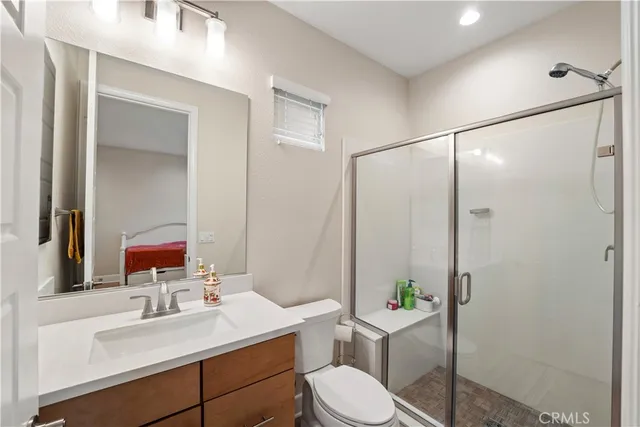 a en suite bathroom with a double vanity sink a mirror and a shower