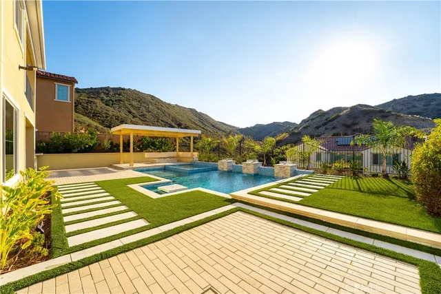 a view of house with pool and outdoor seating
