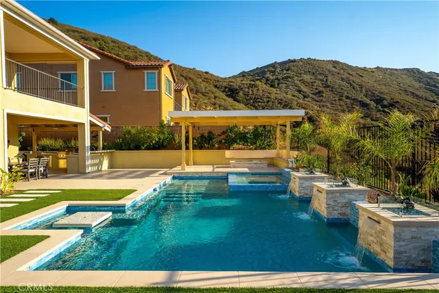 a view of house with garden space and swimming pool