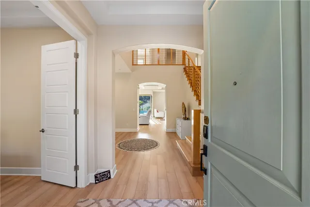 a view of a hallway with wooden floor and staircase