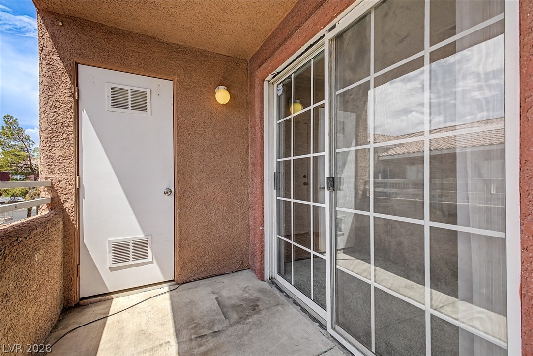4730 East Craig Road, Unit 2096 Las Vegas, NV 89115 - Photo 27 of 35 A private concrete patio area provides access to an additional exterior door and sliding glass doors.
