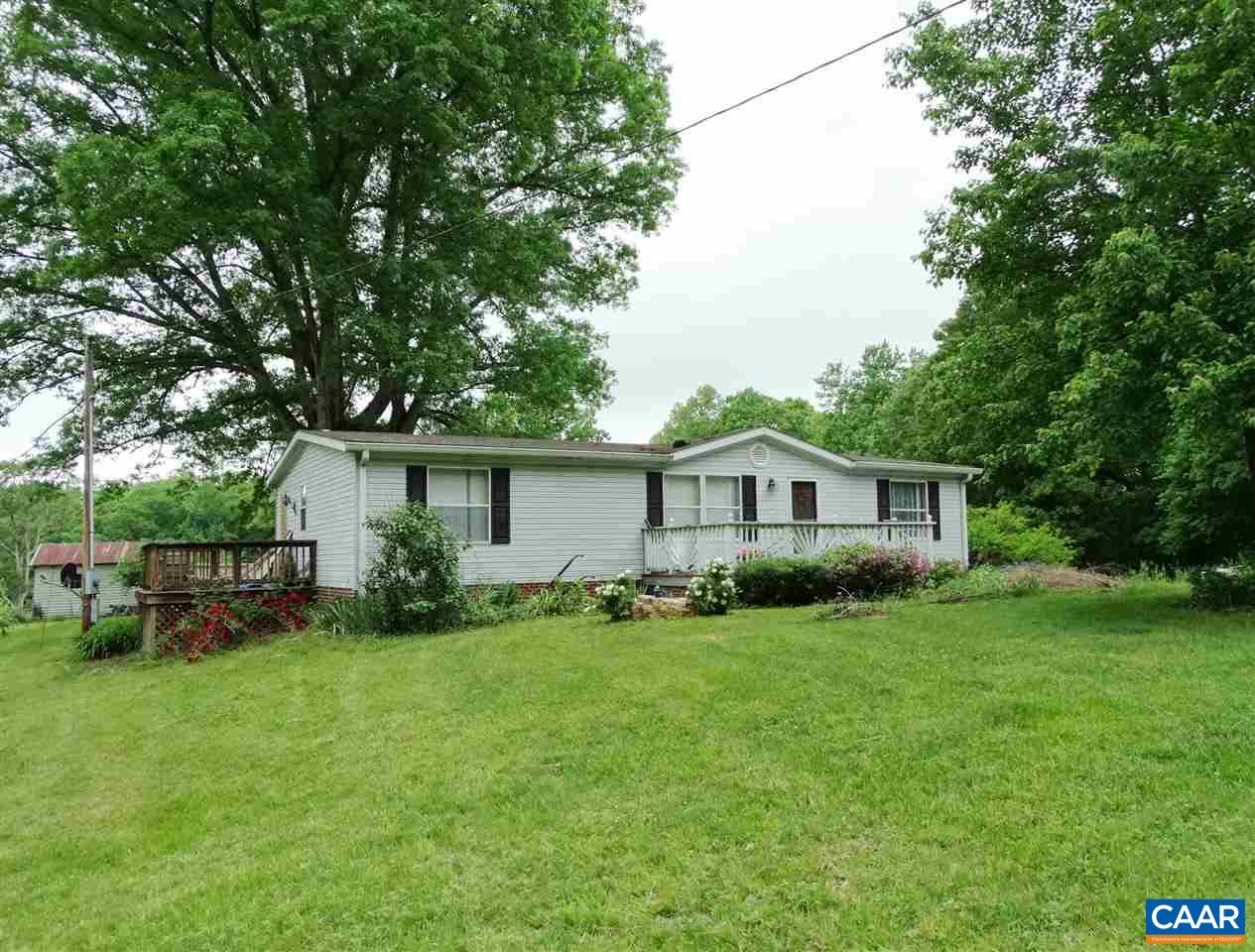 1465 Race Ground Road Rochelle, VA 22738 - Photo 1 of 9 a view of a yard in front of a house with large trees