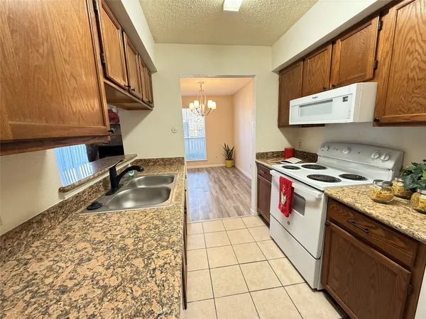 a kitchen that has a sink and a stove