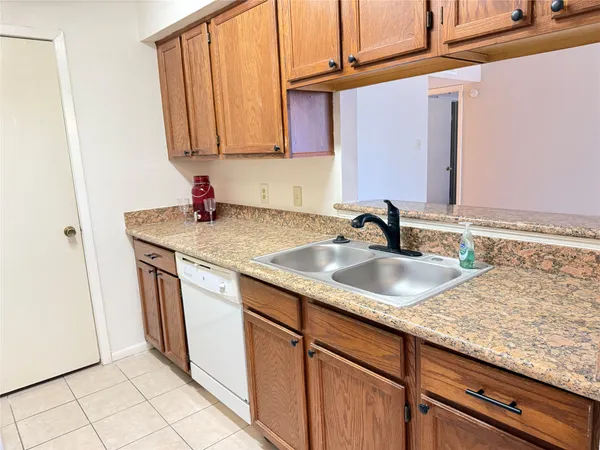 a sink with granite countertop cabinets and sink