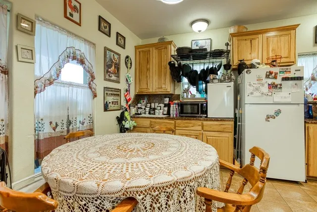 a view of a kitchen with granite countertop and living room