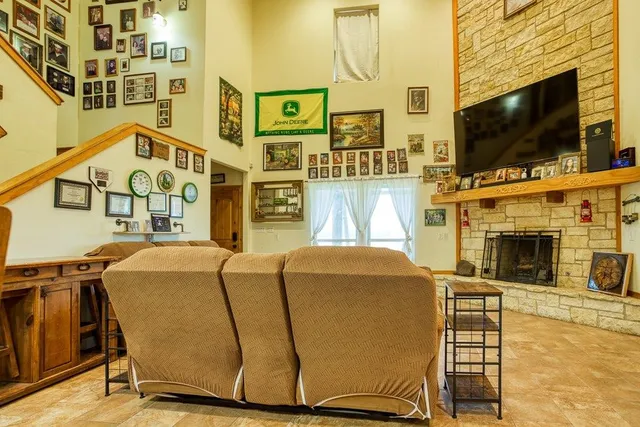 a living room with fireplace furniture and a flat screen tv