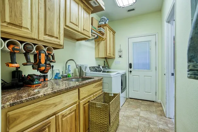 a bathroom with a granite countertop sink toilet and mirror