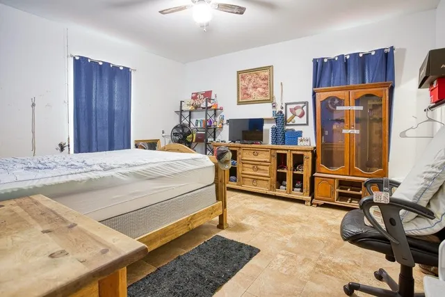 a bedroom with a bed and a table in it