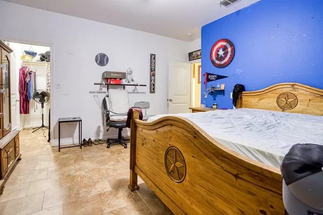 a bedroom with a bed and gym equipment
