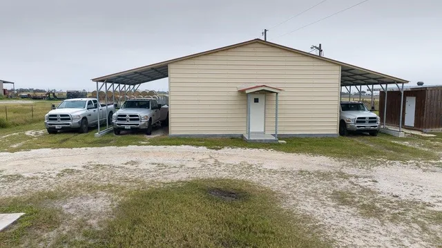 a view of a house with a yard and sitting area