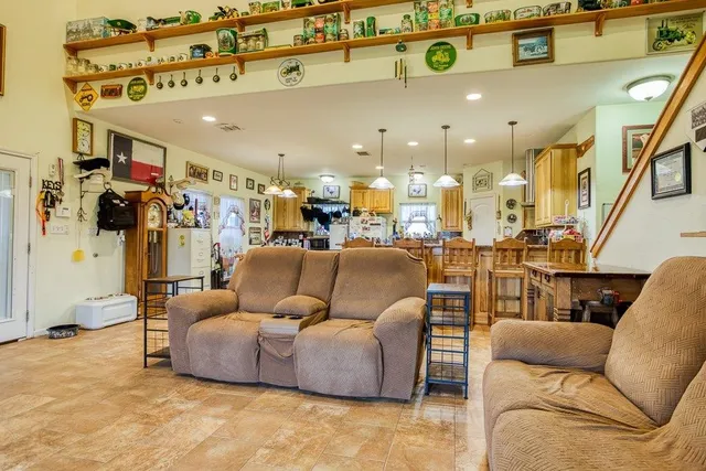 a living room with furniture and a chandelier