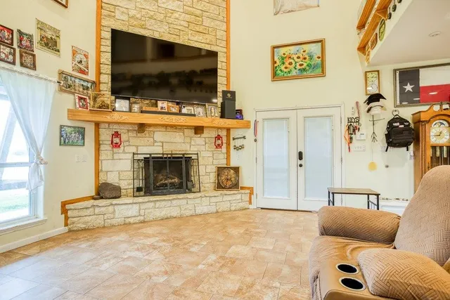 a living room with furniture a flat screen tv and a fireplace