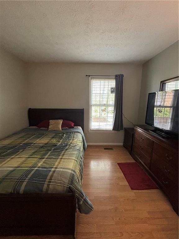 4949 Penscot Way Stone Mountain, GA 30088 - Photo 22 of 40 a bedroom with a bed and window