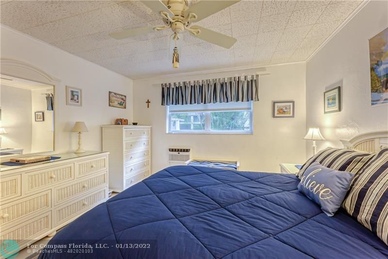 1210 North Riverside Drive, Unit 107 Pompano Beach, FL 33062 - Photo 12 of 29 a bedroom with a bed and wooden floor