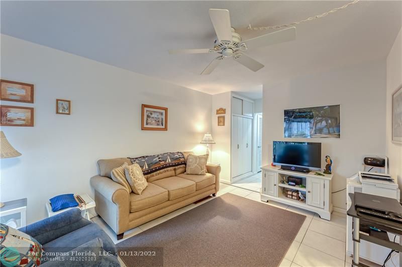 1210 North Riverside Drive, Unit 107 Pompano Beach, FL 33062 - Photo 14 of 29 a living room with furniture and a flat screen tv