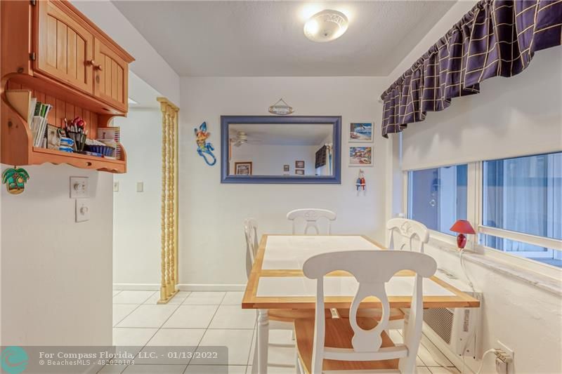 1210 North Riverside Drive, Unit 107 Pompano Beach, FL 33062 - Photo 17 of 29 a living room with furniture and a chandelier