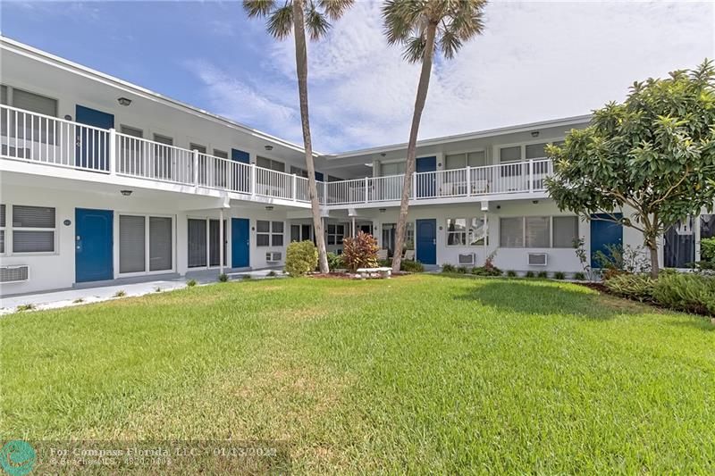 1210 North Riverside Drive, Unit 107 Pompano Beach, FL 33062 - Photo 19 of 29 front view of a building with a garden
