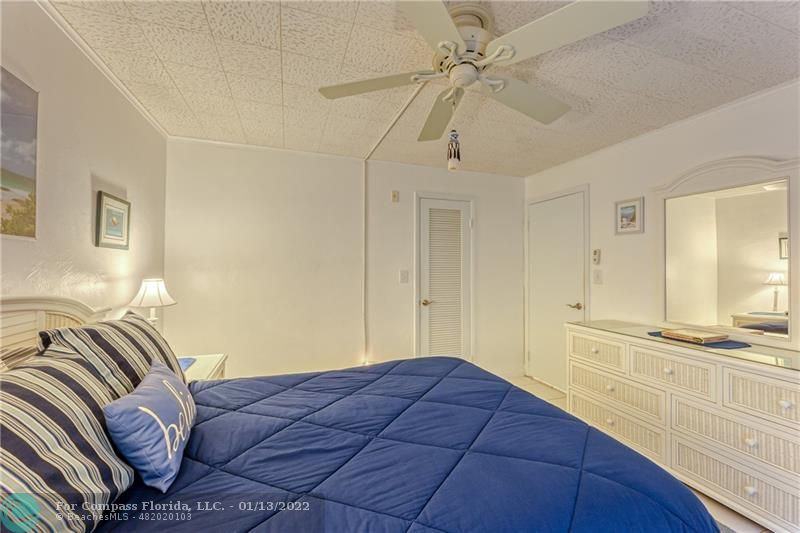 1210 North Riverside Drive, Unit 107 Pompano Beach, FL 33062 - Photo 24 of 29 a bedroom with a bed and a walk in closet
