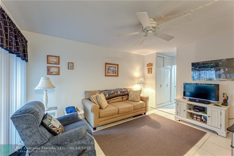 1210 North Riverside Drive, Unit 107 Pompano Beach, FL 33062 - Photo 25 of 29 a living room with furniture and a flat screen tv