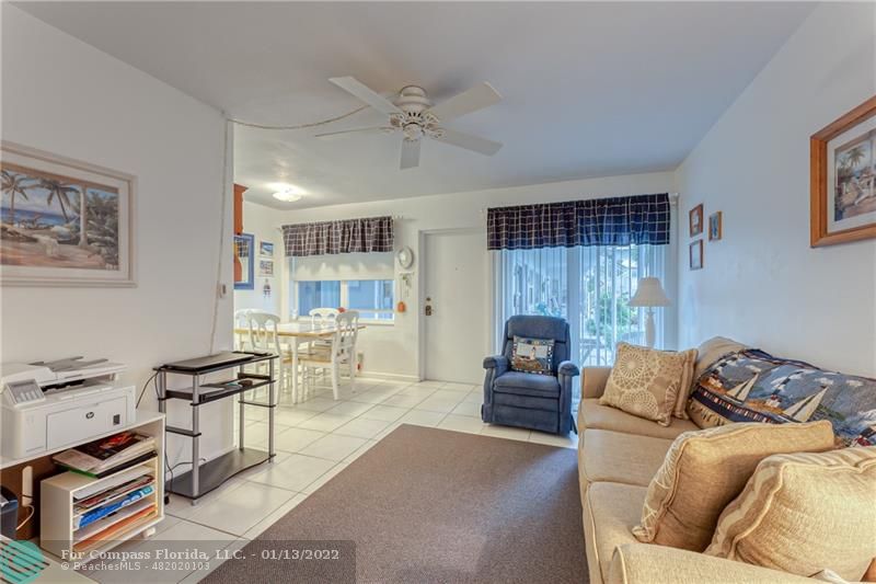 1210 North Riverside Drive, Unit 107 Pompano Beach, FL 33062 - Photo 26 of 29 a living room with furniture fireplace and a view of kitchen