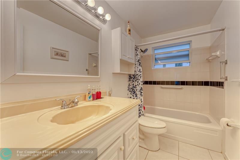 1210 North Riverside Drive, Unit 107 Pompano Beach, FL 33062 - Photo 27 of 29 a bathroom with a sink toilet vanity and shower