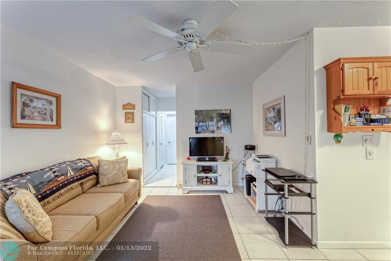 1210 North Riverside Drive, Unit 107 Pompano Beach, FL 33062 - Photo 28 of 29 a living room with furniture and a flat screen tv