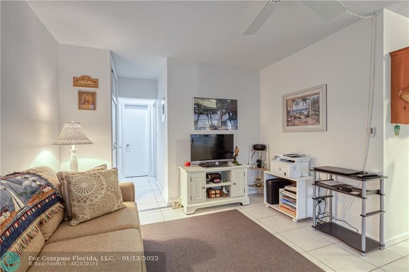 1210 North Riverside Drive, Unit 107 Pompano Beach, FL 33062 - Photo 10 of 29 a living room with furniture and a flat screen tv