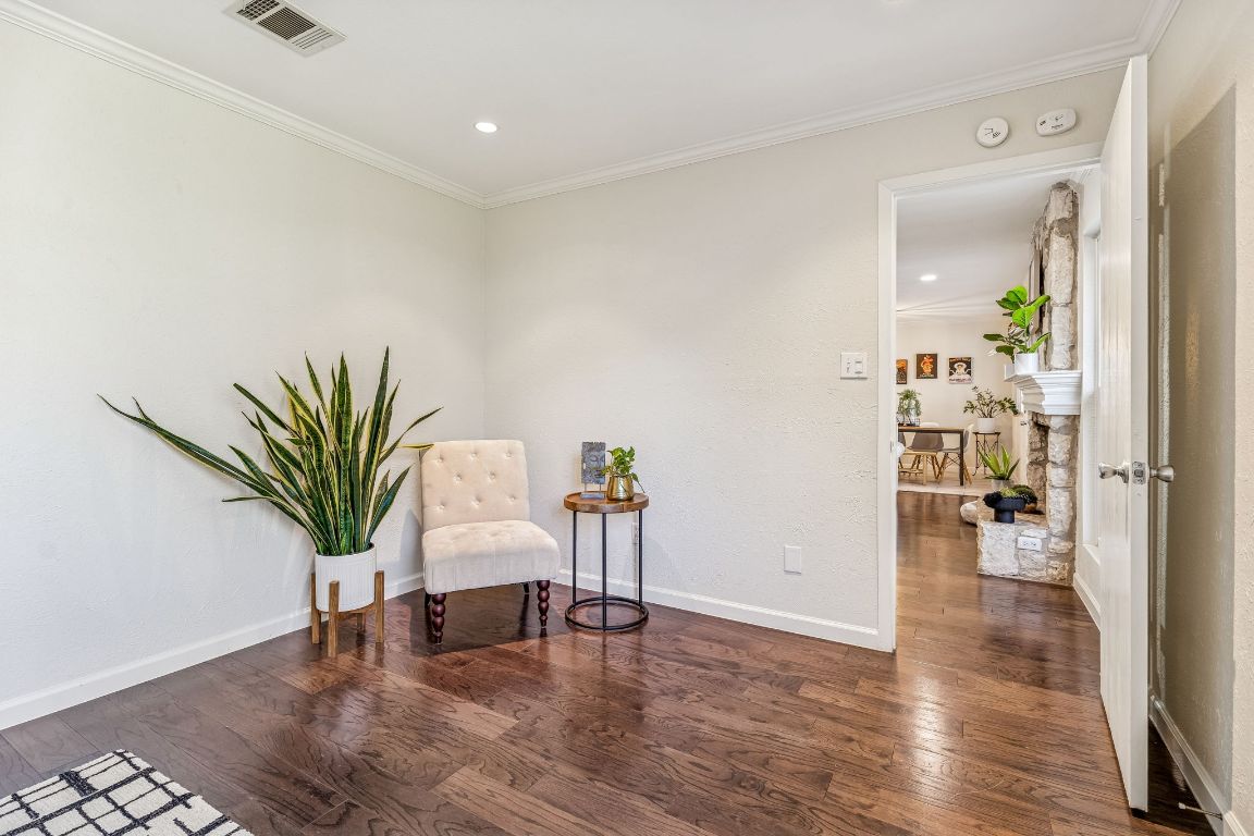 5502 Porsche Lane Austin, TX 78749 - Photo 19 of 32 Living area featuring dark wood finished floors, ornamental molding, and recessed lighting