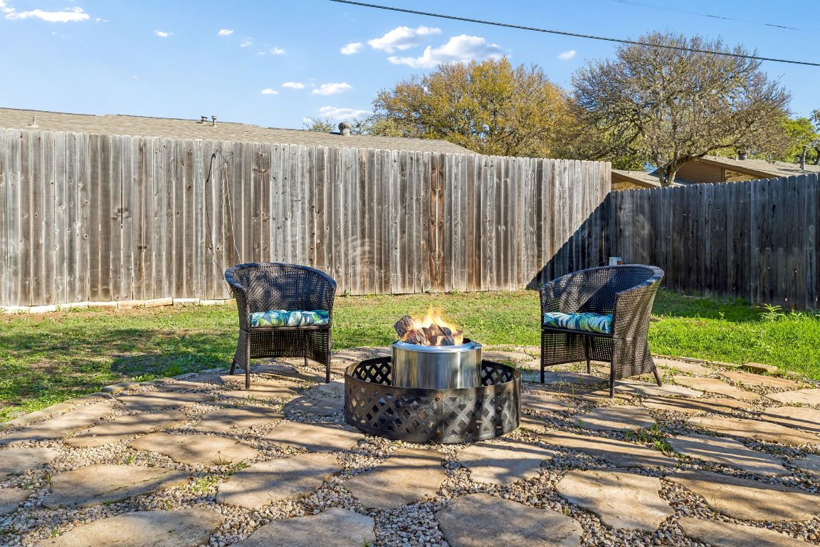 5502 Porsche Lane Austin, TX 78749 - Photo 32 of 32 Fenced backyard featuring an outdoor fire pit and a patio area