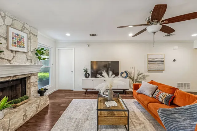 a living room with furniture a fireplace and a flat screen tv
