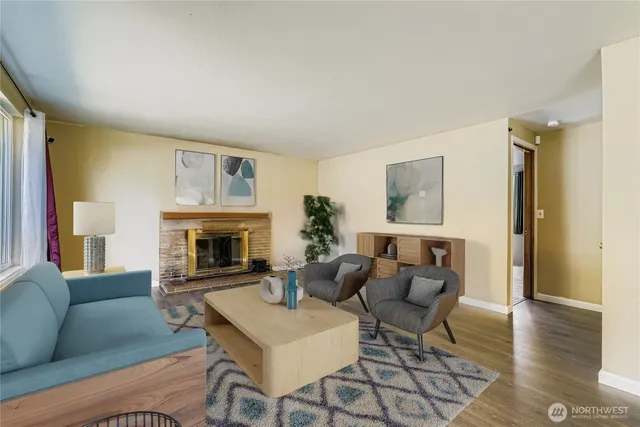 a living room with furniture and a fireplace