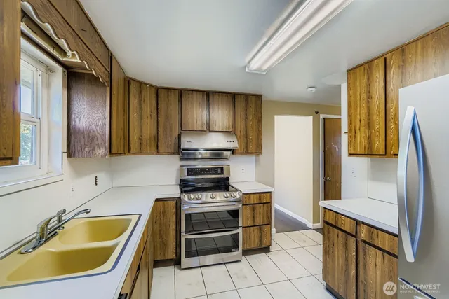 a kitchen with a sink a stove and refrigerator