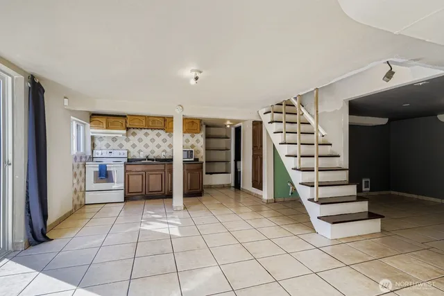 a view of a kitchen with electric appliances and cabinets