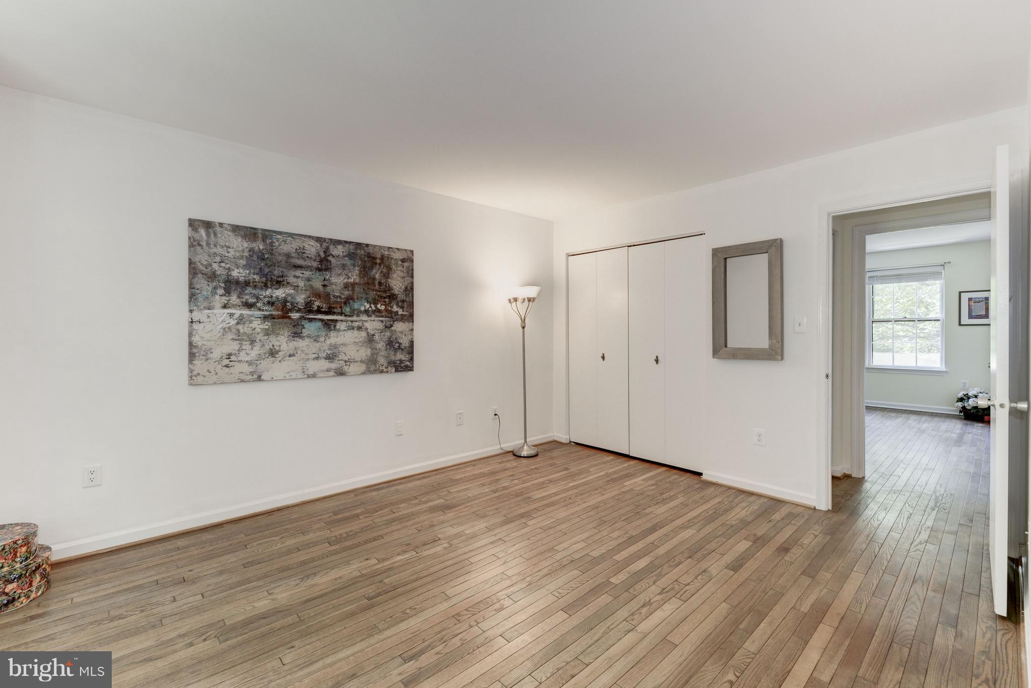 2100 Golf Course Drive Reston, VA 20191 - Photo 13 of 30 an empty room with wooden floor and windows