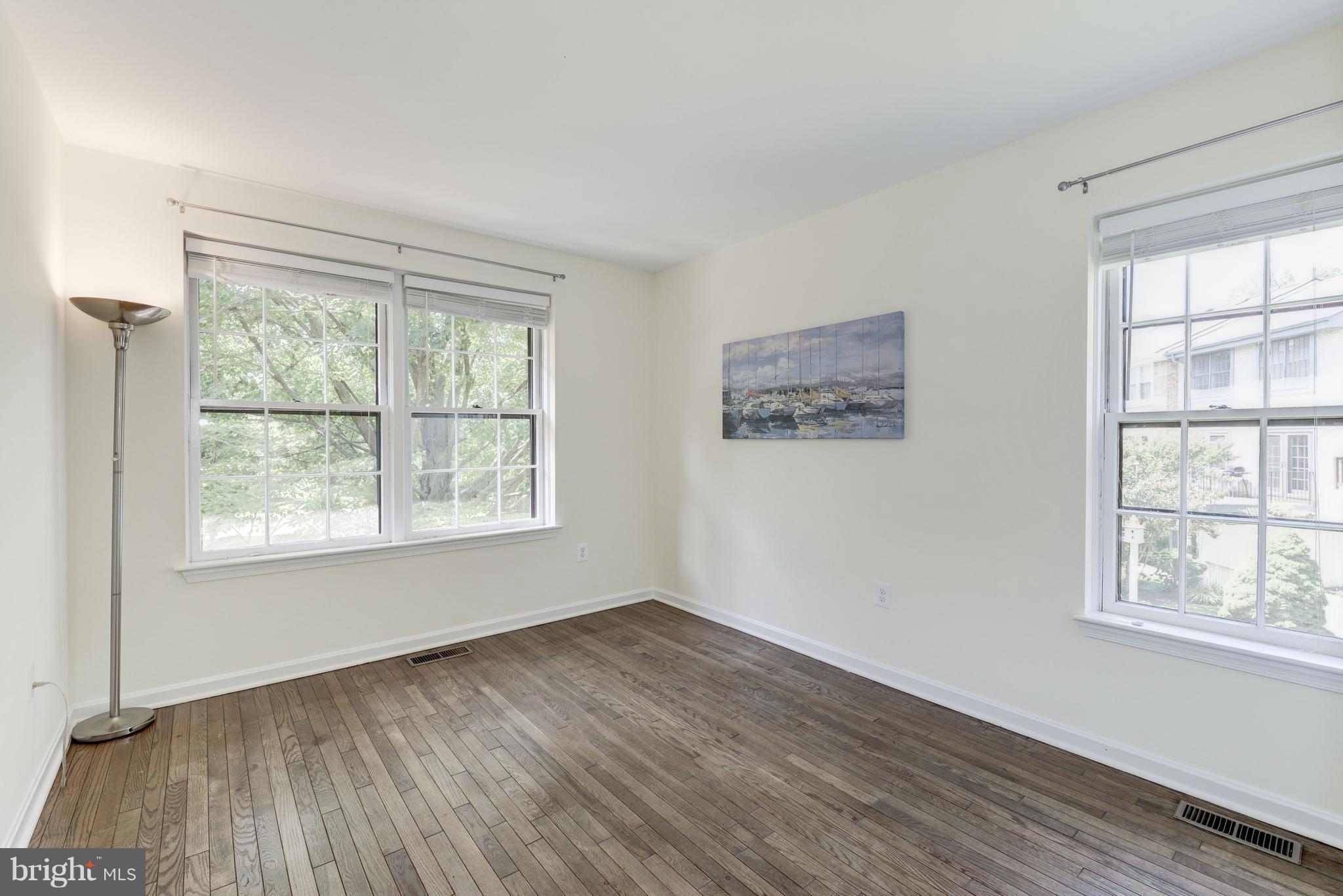 2100 Golf Course Drive Reston, VA 20191 - Photo 15 of 30 an empty room with wooden floor and windows