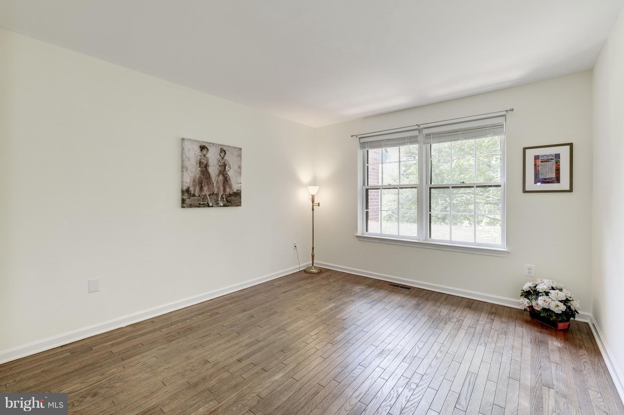 2100 Golf Course Drive Reston, VA 20191 - Photo 16 of 30 an empty room with wooden floor and windows