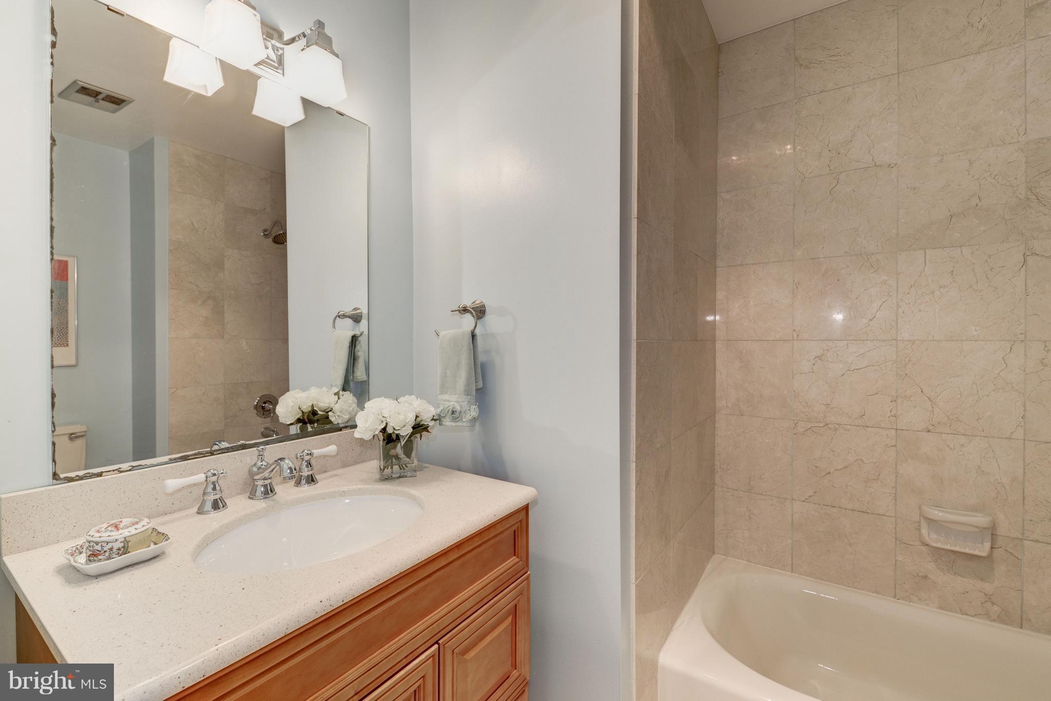 2100 Golf Course Drive Reston, VA 20191 - Photo 17 of 30 a bathroom with a sink and a mirror