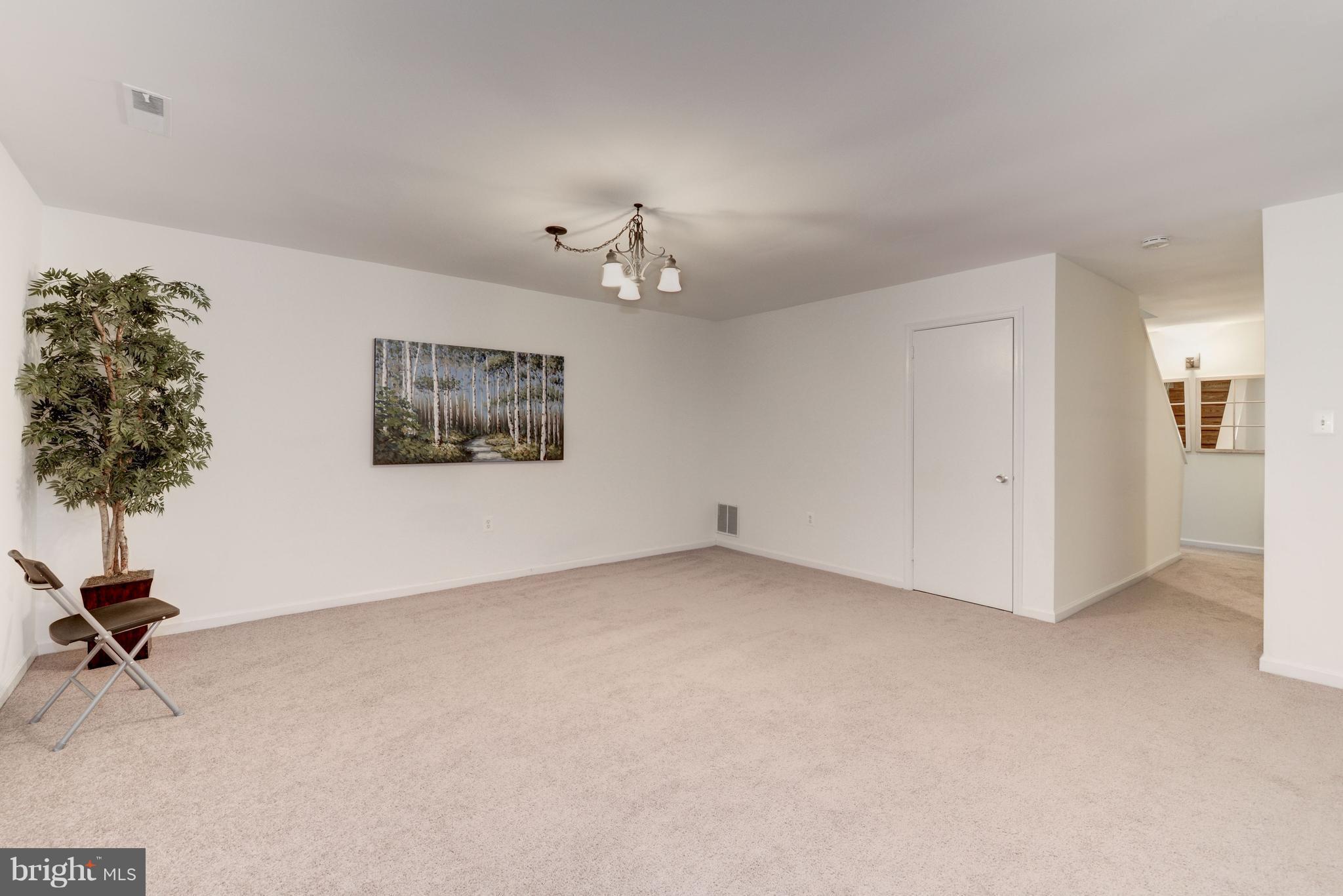 2100 Golf Course Drive Reston, VA 20191 - Photo 20 of 30 a view of a room with a chandelier fan and wooden floor