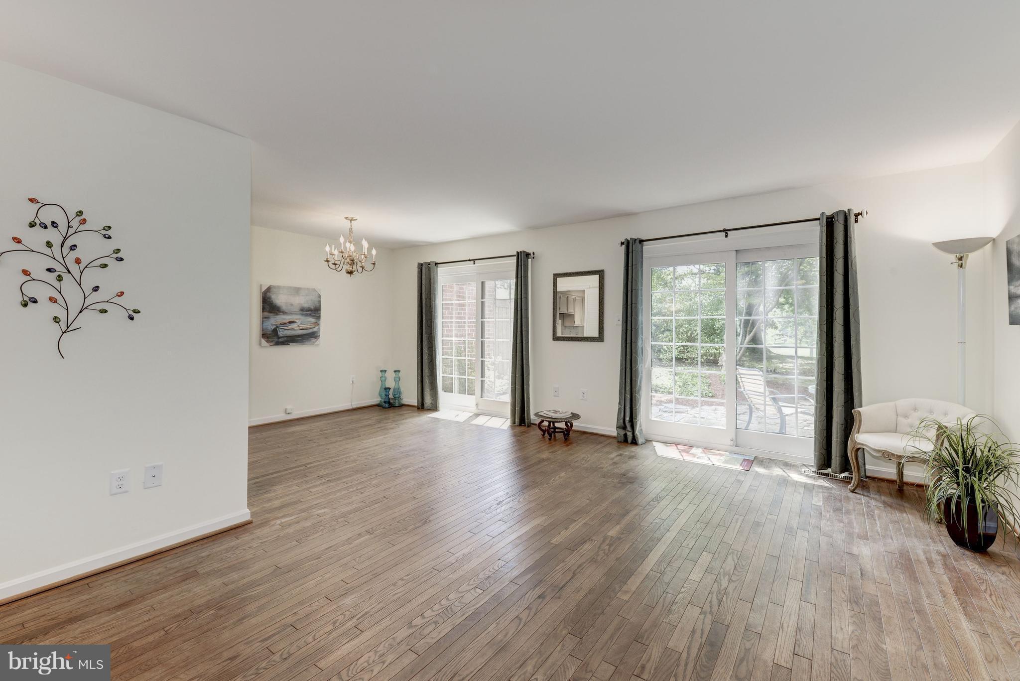 2100 Golf Course Drive Reston, VA 20191 - Photo 4 of 30 a view of a big room with wooden floor and windows