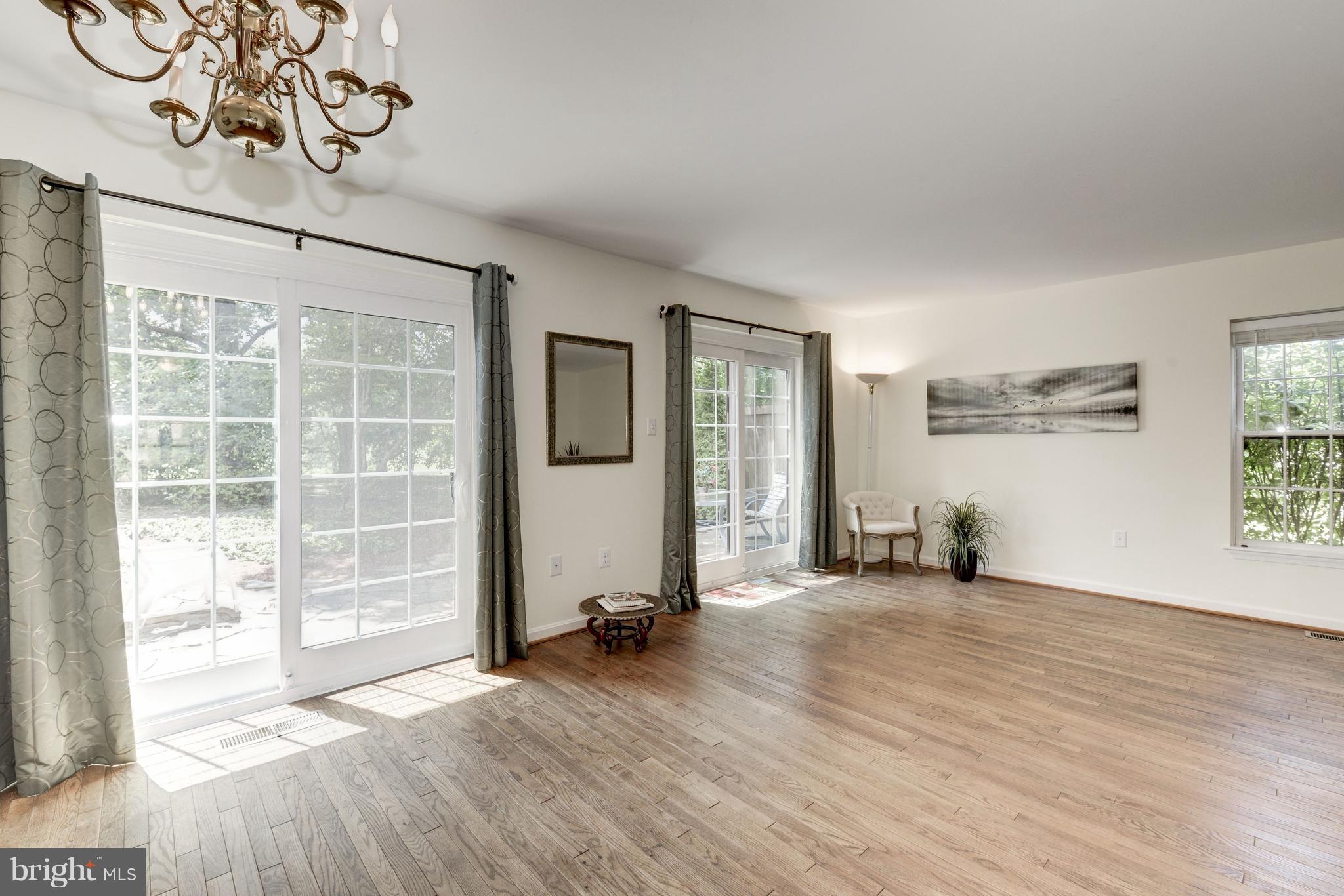2100 Golf Course Drive Reston, VA 20191 - Photo 5 of 30 an empty room with wooden floor and windows