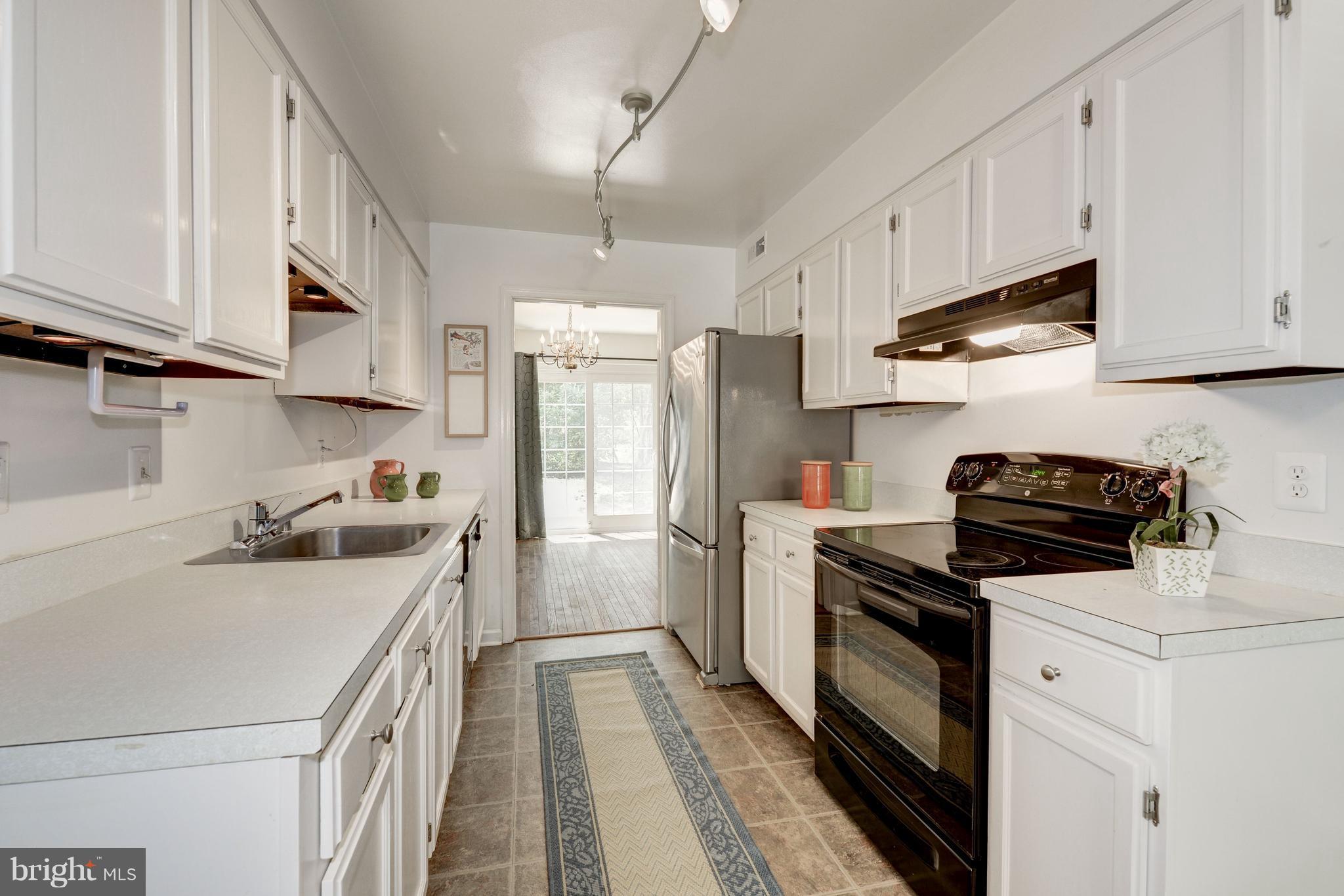 2100 Golf Course Drive Reston, VA 20191 - Photo 7 of 30 a kitchen with a sink a stove and refrigerator