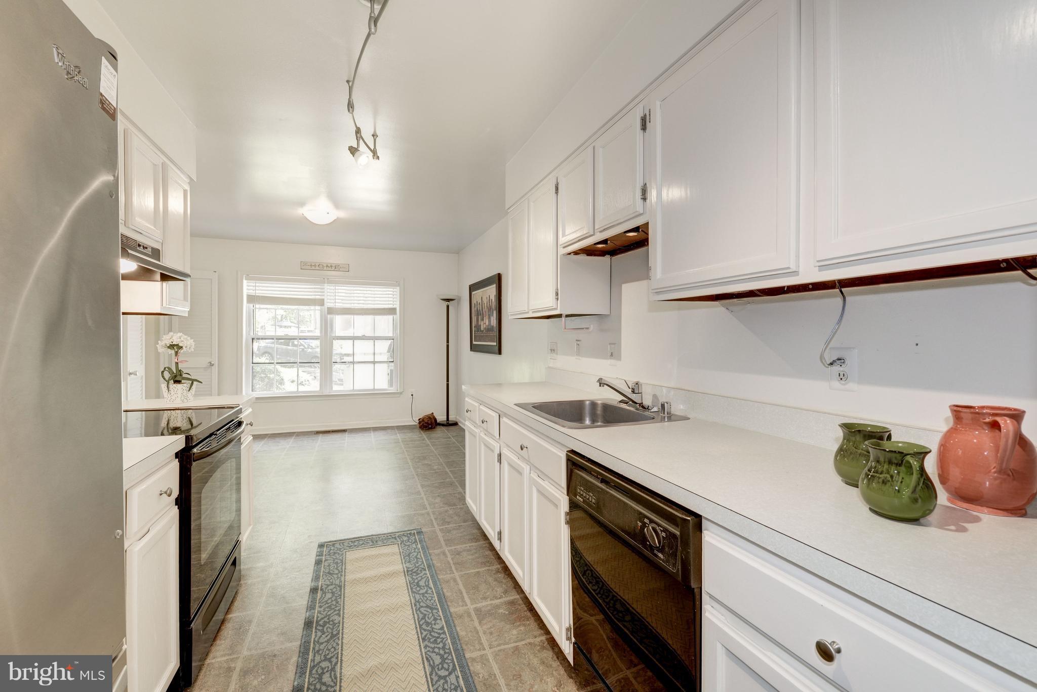 2100 Golf Course Drive Reston, VA 20191 - Photo 8 of 30 a kitchen with a sink stove and cabinets