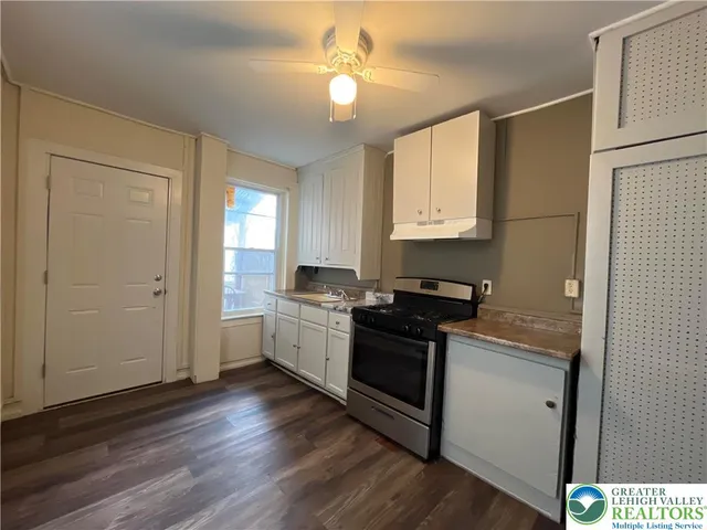 a kitchen with stainless steel appliances granite countertop a stove and a refrigerator