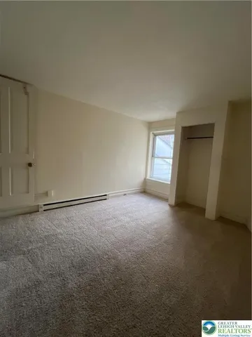 an empty room with a empty space and window