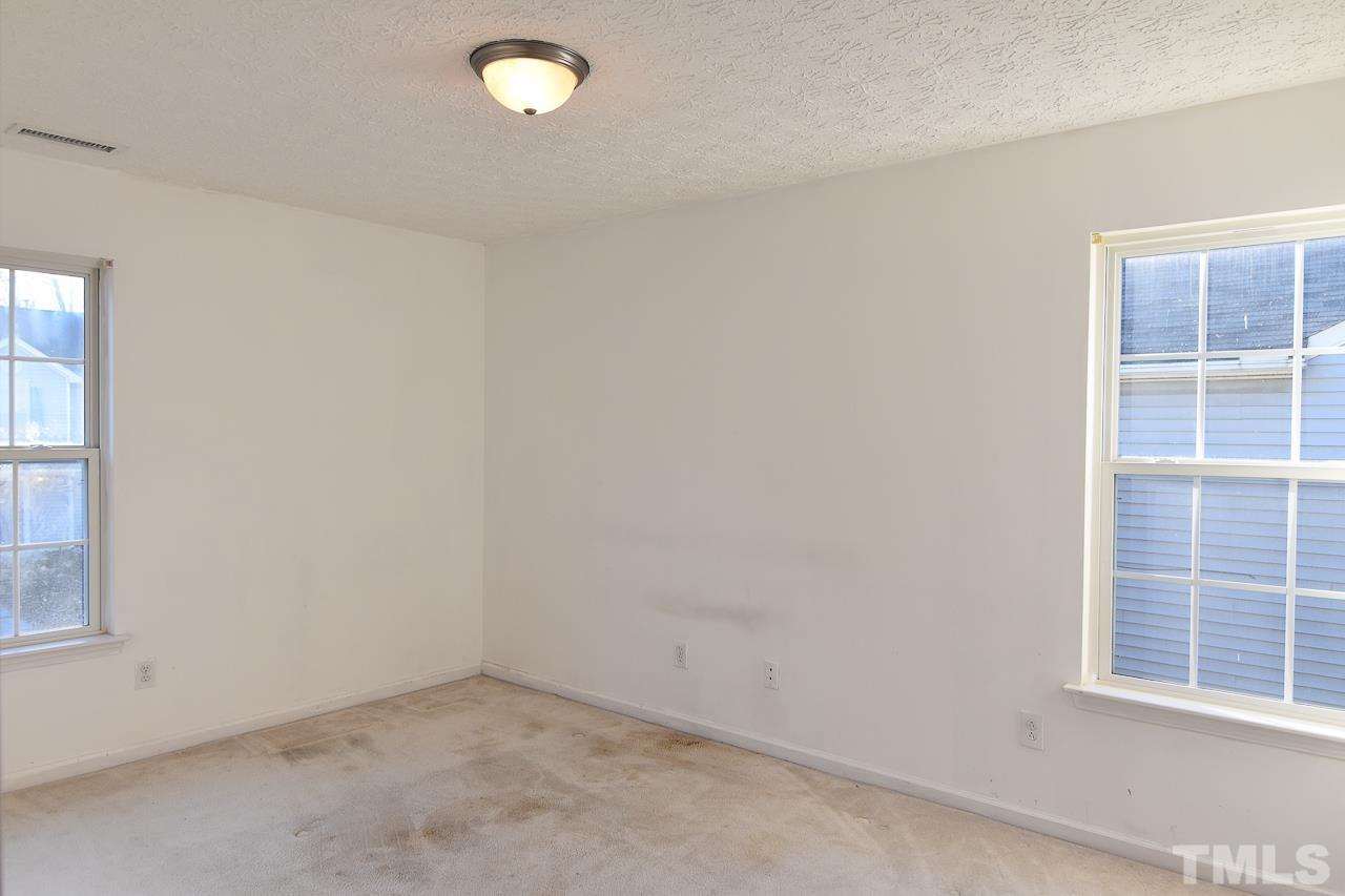 5709 Forest Point Road Raleigh, NC 27610 - Photo 14 of 19 an empty room with windows
