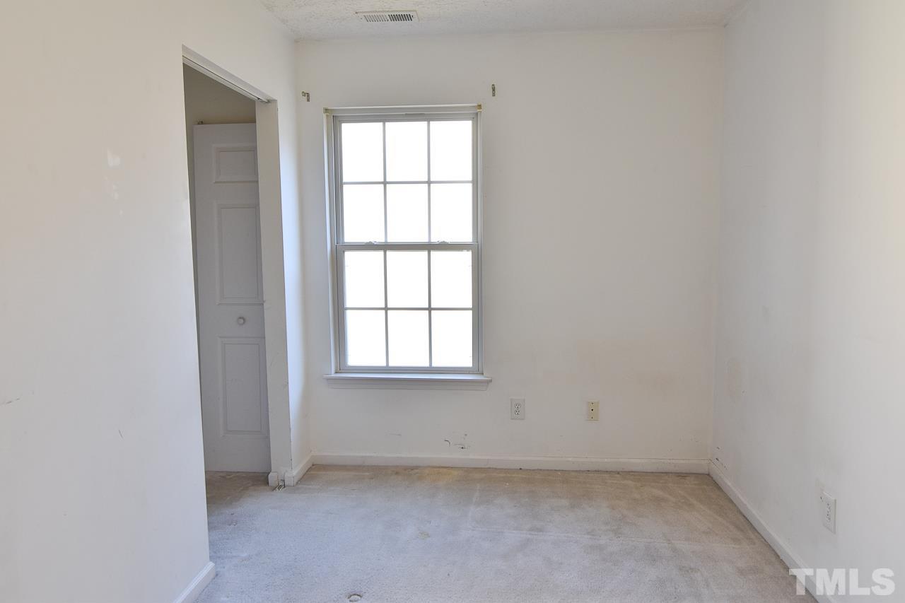 5709 Forest Point Road Raleigh, NC 27610 - Photo 16 of 19 an empty room with a window