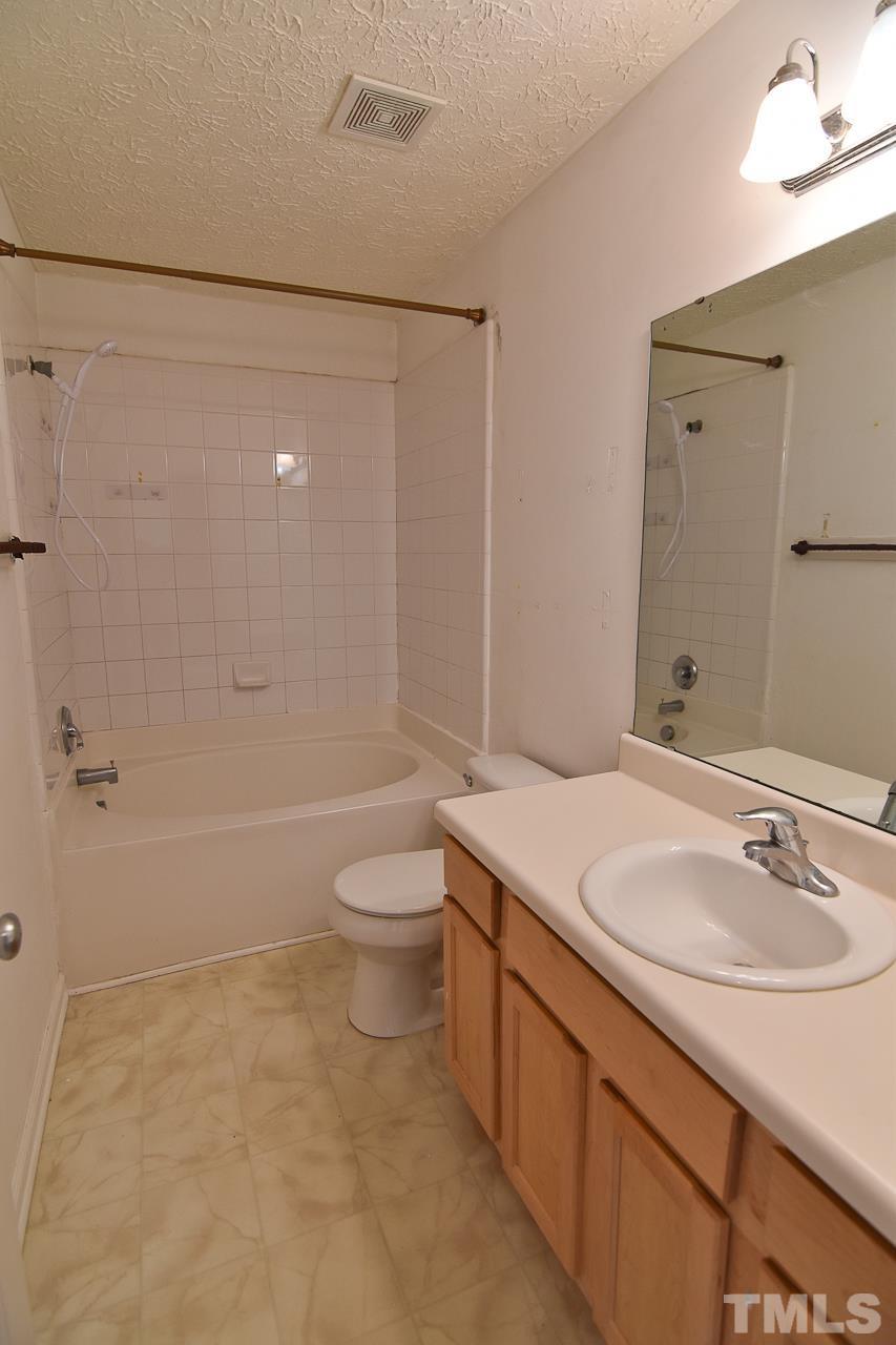 5709 Forest Point Road Raleigh, NC 27610 - Photo 17 of 19 a bathroom with a sink a toilet and shower