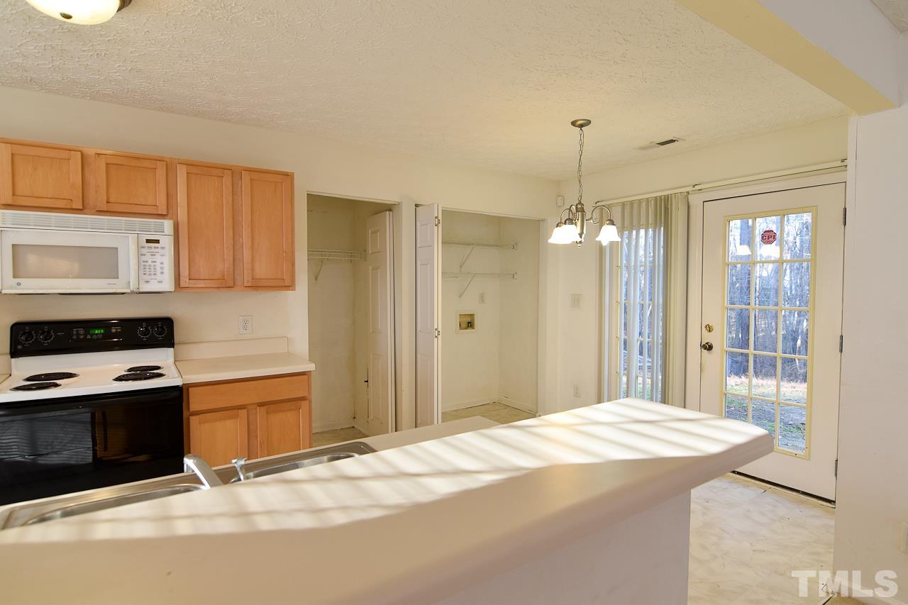 5709 Forest Point Road Raleigh, NC 27610 - Photo 4 of 19 a bedroom with a bed dresser and a window