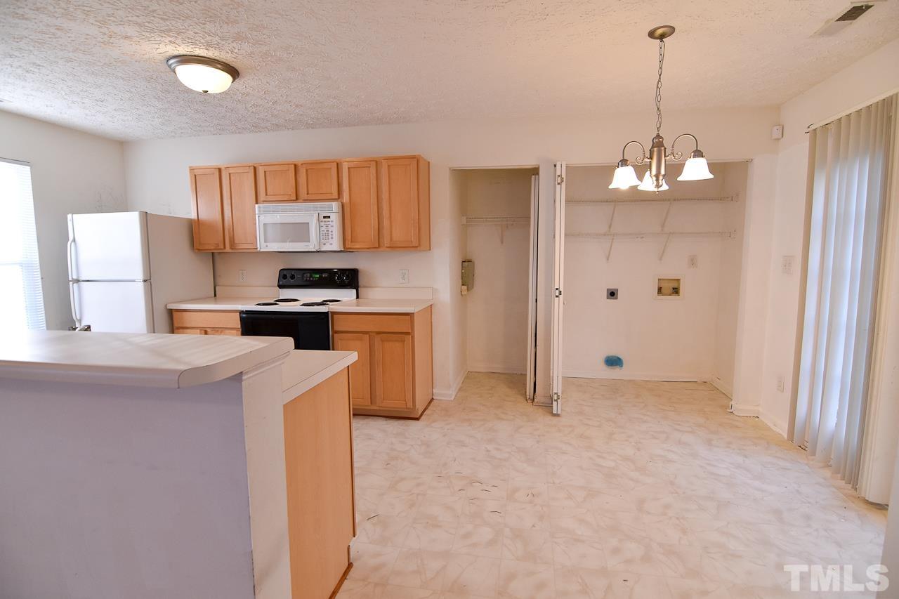 5709 Forest Point Road Raleigh, NC 27610 - Photo 5 of 19 a kitchen that has a lot of cabinets in it