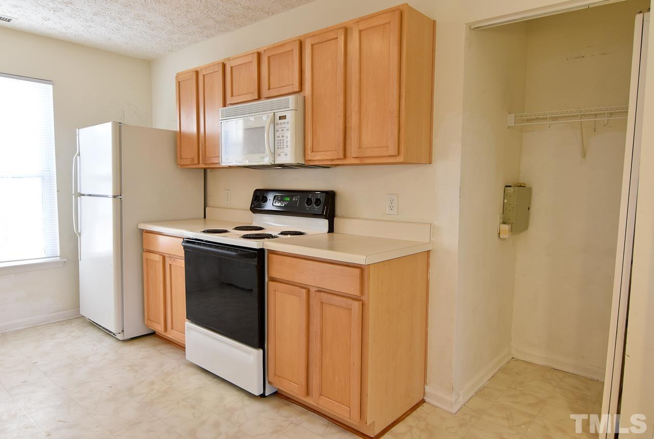 5709 Forest Point Road Raleigh, NC 27610 - Photo 6 of 19 a kitchen with stainless steel appliances a refrigerator and a stove